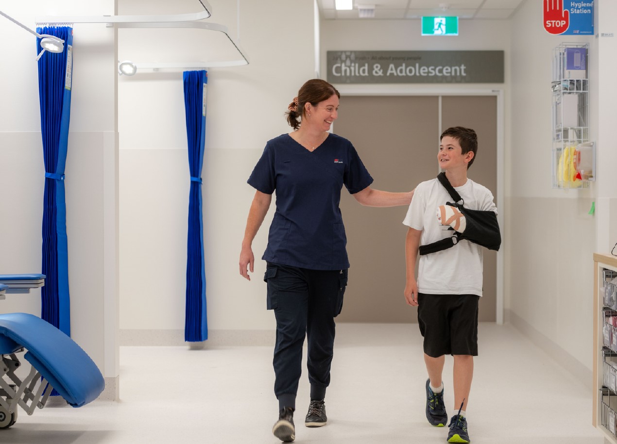 Nurse providing care to child with injured arm